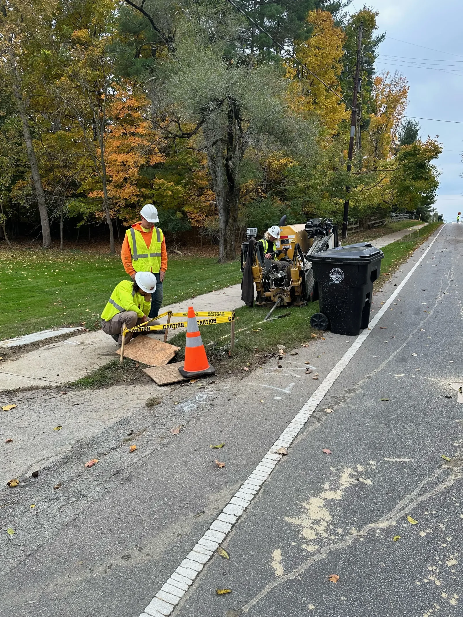 Directional drilling crew running a bore rig roadside