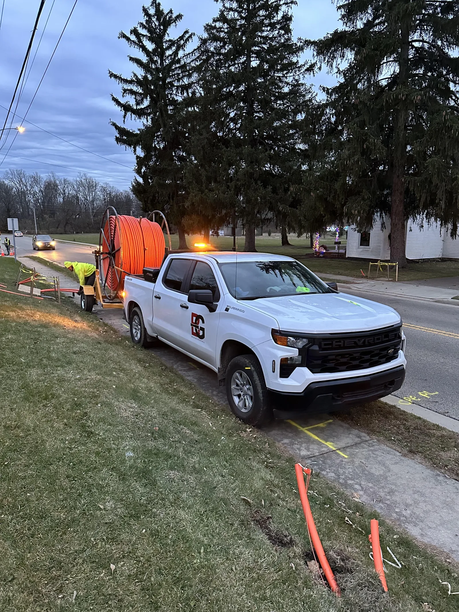 B&G truck and conduit reel at a job site at dusk